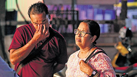 Santon Lama breaks down as he reaches Kalamassery police station with his mother Reena on Friday night to complete clearance formalities for receiving the mortal remains of his father Suraj Lama