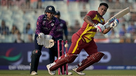West Indies' Shimron Hetmyer plays a shot as Scotland's wicketkeeper Matthew Cross watches during the 2026 ICC Men's T20 Cricket World Cup group stage match between Scotland and West Indies at the Eden Gardens in Kolkata on February 7, 2026.