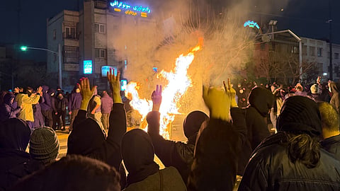 Iranians attend an anti-government protest in Tehran, Iran, Friday, Jan. 9, 2026.