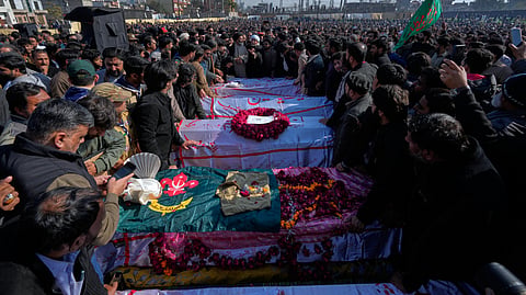 Mourners arrange the coffins of the victims of Friday's suicide bombing inside a Shiite mosque, during a funeral prayer, in Islamabad, Pakistan, Saturday, Feb. 7, 2026.
