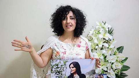 In this photo released by the Narges Foundation Archive, Nobel Peace Prize laureate Narges Mohammad is seen after being released on a medical furlough in Tehran, Iran, Wednesday, Dec. 4, 2024. On her hand written in Farsi is "End gender apartheid.