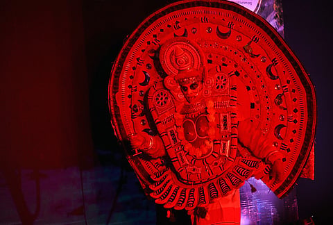A Theyyam artist performs in vibrant traditional attire during the Kerala Tourism Meet