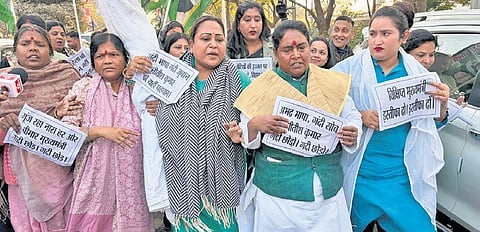 Women members of the Opposition protesting with placards on Tuesday