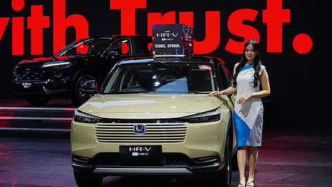 A model poses near a Honda HR-V car during the Indonesian International Motor Show in Jakarta, Indonesia, Thursday, Feb. 5, 2026.
