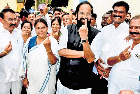 Irrigation Minister N Uttam Kumar Reddy shows his inked finger after casting his vote at a polling booth in the 14th ward of Kodad on Wednesday