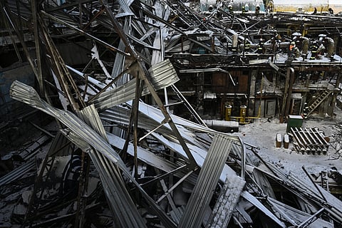 Rescuers of the State Emergency Service and employees of a power plant clear debris at a heavily damaged thermal power plant of the Ukrainian energy provider DTEK in an undisclosed location in Ukraine on February 9, 2026, following Russian missile and drone strikes amid the Russian invasion of Ukraine.