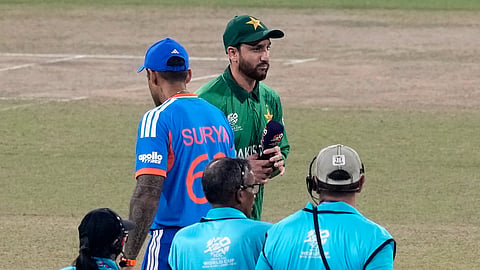 India's captain Suryakumar Yadav, left, and Pakistan's captain Salman Ali Agha walk past each other after the coin toss of the T20 World Cup cricket match between India and Pakistan in Colombo, Sri Lanka, Sunday, Feb. 15, 2026.