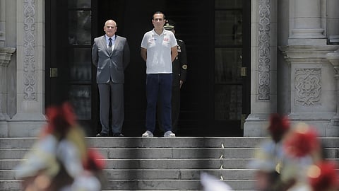 Peru's President Jose Jeri, right, stands with Prime Minister Ernesto Alvarez during the changing of the guard ceremony at the government palace in Lima, Peru, Tuesday, Feb. 17, 2026.