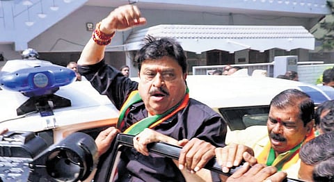 BJP state president N Ramchander Rao raises a slogan as he is being shifted to Bollarum police station on Sunday