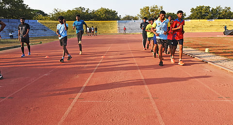 Athletes training on the damaged synthetic track at Anna stadium in Tiruchy.