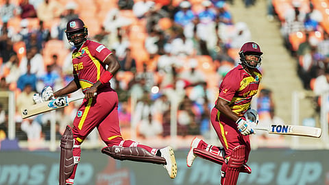 West Indies' Jason Holder, left, and batting partner Romario Shepherd run between the wickets during the T20 World Cup cricket match between South Africa and West Indies in Ahmedabad, India, Thursday, Feb. 26, 2026.