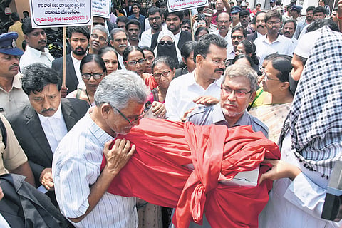Parents of Ayesha Meera carry her remains from the court complex in Vijayawada
on Friday