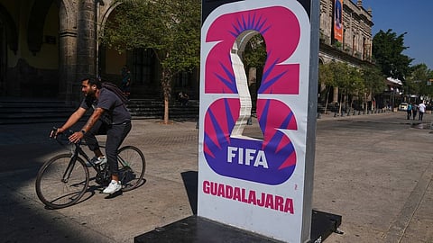 A cyclist rides past an installation promoting the FIFA World Cup 2026 in Guadalajara, Mexico, Wednesday, Feb. 25, 2026.