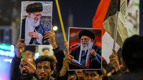 Iraqi Shiites hold pictures of Iranian Supreme Leader Ayatollah Ali Khamenei, who was killed by a U.S. airstrike in Tehran, during a symbolic funeral, in Najaf, Iraq, Sunday, March 1, 2026.