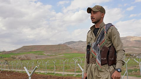 Member of the Democratic Party of Iranian Kurdistan PDKI stands at a checkpoint leading to their base in Koya district of Irbil, Iraq, Friday, Feb. 27, 2026.