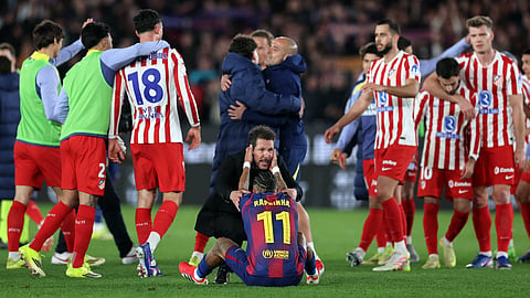 Atletico Madrid coach Diego Simeone (C) conforts Barcelona's Brazilian forward Raphinha at the end of the Copa del Rey (King's Cup) semi final second leg football match between FC Barcelona and Club Atletico de Madrid on March 3, 2026.