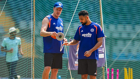 India's Varun Chakravarthy, right, and bowling coach Morne Morkel during a practice session ahead of the ICC Men's T20 World Cup 2026 second semifinal cricket match between India and England, at the Wankhede Stadium, in Mumbai, Wednesday, March 4, 2026.