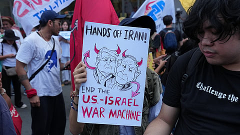 Protesters hold a caricature of US President Donald Trump and Israeli Prime Minister Benjamin Netanyahu during a rally in solidarity with Iran after they were blocked by police as they marched towards the US embassy in Manila, Philippines, on Tuesday, March 3, 2026.