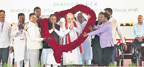 Union Home Minister Amit Shah, Chief Minister Mohan Charan Majhi and Union Education Minister Dharmendra Pradhan being felicitated at the event