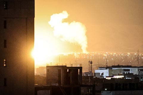 Smoke and fire rise from the site of airstrikes in a central area of the Iranian capital Tehran.