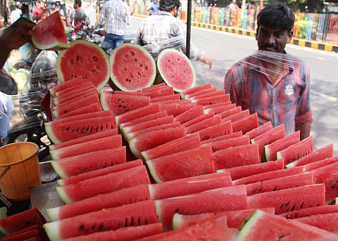 A vendor sells watermelon slices in Visakhapatnam on Friday