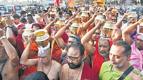 Priests carry holy water in vessels as part of ‘Kalasa Uregimpu’ at Kanaka Durga Nagar in Vijayawada on Friday