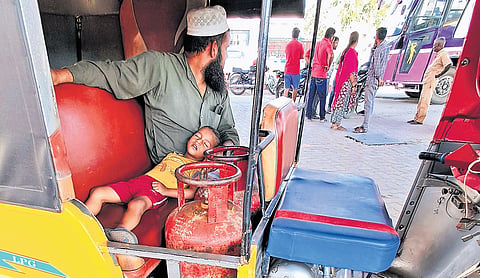 A Chennai resident waiting with empty cylinders outside an LPG bunk at Madhavaram