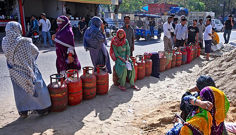 People wait in a queue with LPG cylinders amid a supply crisis, in Jaipur, Sunday, March 15, 2026.