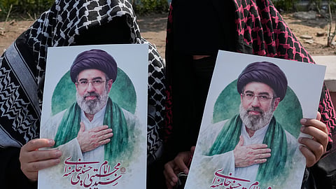 Women hold posters of the Iranian Supreme Leader Ayatollah Mojtaba Khamenei during a campaign in support of the government at the Enqelab-e-Eslami, or Islamic Revolution, square in downtown Tehran, Iran, Saturday, March 14, 2026.