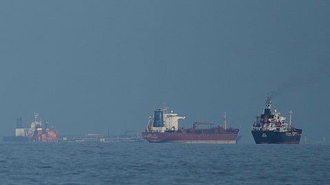 Tankers and cargo ships line up in the Strait of Hormuz as seen from Khor Fakkan, UAE