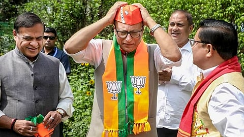 Assam Chief Minister Himanta Biswa Sarma, left, and BJP Assam president Dilip Saikia, right, welcome Nagaon MP Pradyut Bordoloi into the Bharatiya Janata Party, in New Delhi.