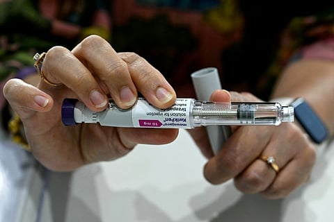 This photograph taken on March 17, 2026 shows obesity doctor and consultant Swati Pradhan explaining the Mounjaro GLP-1 self-injectable device at her clinic in Mumbai.