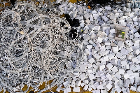 Used charging cables and power adapters are piled up at a shop in Nhat Tao market, the largest informal recycling market in Ho Chi Minh City, Vietnam, Jan. 28, 2024.