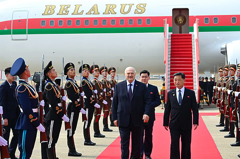 In this photo released by Belarus' Presidential Press Service, Belarusian President Alexander Lukashenko, center, arrives to the Pyongyang International Airport, outside Pyongyang, North Korea, Wednesday, March 25, 2026.