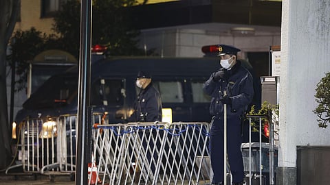 Police officers stand guard in front of the Chinese Embassy in Tokyo Tuesday, March 24, 2026, after an alleged break-in by a Japan Self-Defense Forces member.