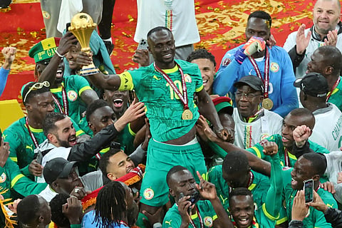 Senegal's Sadio Mane holds the trophy aloft as he celebrates with teammates after winning the Africa Cup of Nations final soccer match between Senegal and Morocco in Rabat, Morocco, Sunday, Jan. 18, 2026.