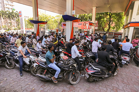 People queue up at a petrol pump amid rumours of fuel shortage in the wake of the West Asian conflict, in Prayagraj, Uttar Pradesh, Thursday, March 26, 2026.