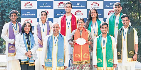 Divya Dwivedi (centre, with award), and nine gold medalists from various disciplines
at the 51st convocation of IIMB on Friday
