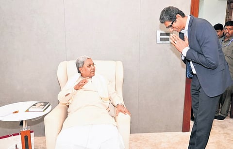 Former cricketer and KSCA president Venkatesh Prasad greets Chief Minister Siddaramaiah in Bengaluru on Friday