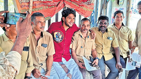 File | Twenty20 candidate Akhil Marar interacts with autorickshaw drivers near the Cochin Special Economic Zone in Kakkanad during campaigning for the 2026 Kerala Assembly election from the Thrikkakara constituency.