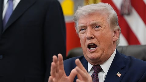 President Donald Trump answers questions from reporters after signing an executive order in the Oval Office of the White House Tuesday, March 31, 2026, in Washington.