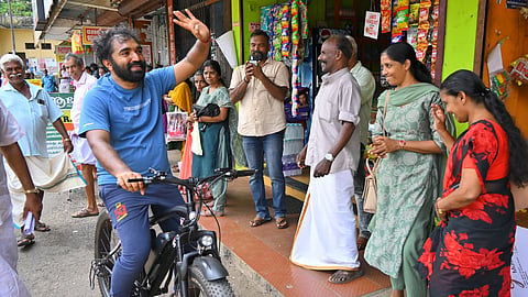 UDF candidate for Puthuppally, Chandy Oommen engaging with the voters on his cycle.