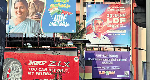 Three political parties contesting to lead Kerala in the Kerala Legislative Assembly election have displayed their slogans together at Vyttila main junction.