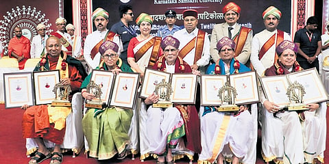 Governor Thaawarchand Gehlot and MP Dr C N Manjunath with DLitt awardees Bhikkhu Ananda Thero, Pushpa Dixit, Vyasanakere Prabhanjanacharya, Nirmalanandanatha Swamiji and Sukant Kumar Senapati during the convocation of Karnataka Samskrit University at in Bengaluru on Tuesday