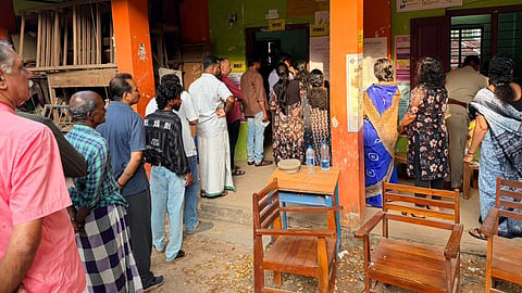 Voters queue up to cast their votes at Government High School, Kachani, in Vattiyoorkavu constituency, Thiruvananthapuram, during the first hour of polling in the Assembly elections on Thursday.