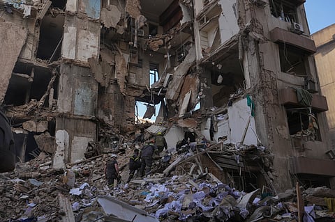 Lebanese civil defense workers search for victims in the rubble of a building destroyed in an Israeli airstrike a day earlier in central Beirut, Lebanon, Thursday, April 9, 2026.