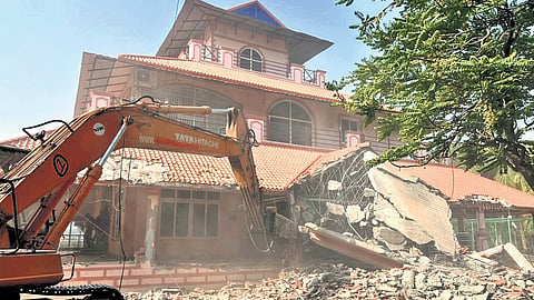 A bulldozer deployed by HYDRAA razes a farmhouse linked to MA Mokheem, an advocate, in Ailapur of Ameenpur mandal, Sangareddy district, on Saturday