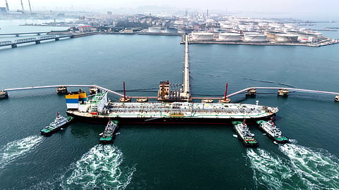 Tugboats push a crude oil tanker into position at a pier handling oil imports in Qingdao in eastern China's Shandong province, Saturday, April 11, 2026.