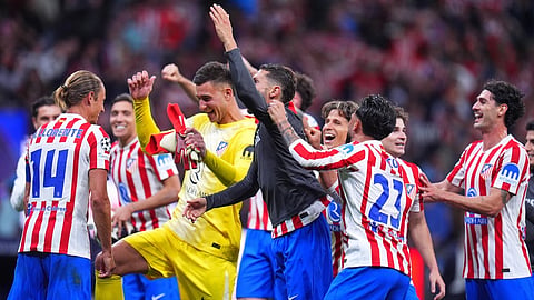Atletico Madrid's players celebrate at the end of the Champions League quarterfinal second leg soccer match between Atletico Madrid and Barcelona in Madrid, Spain, Tuesday, April 14, 2026.