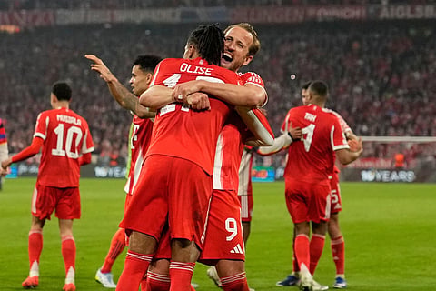 Bayern's Michael Olise celebrates with Harry Kane after scoring his side's fourth goal during the Champions League quarterfinal second leg soccer match between Bayern Munich and Real Madrid in Munich, Germany, Wednesday, April 15, 2026.
